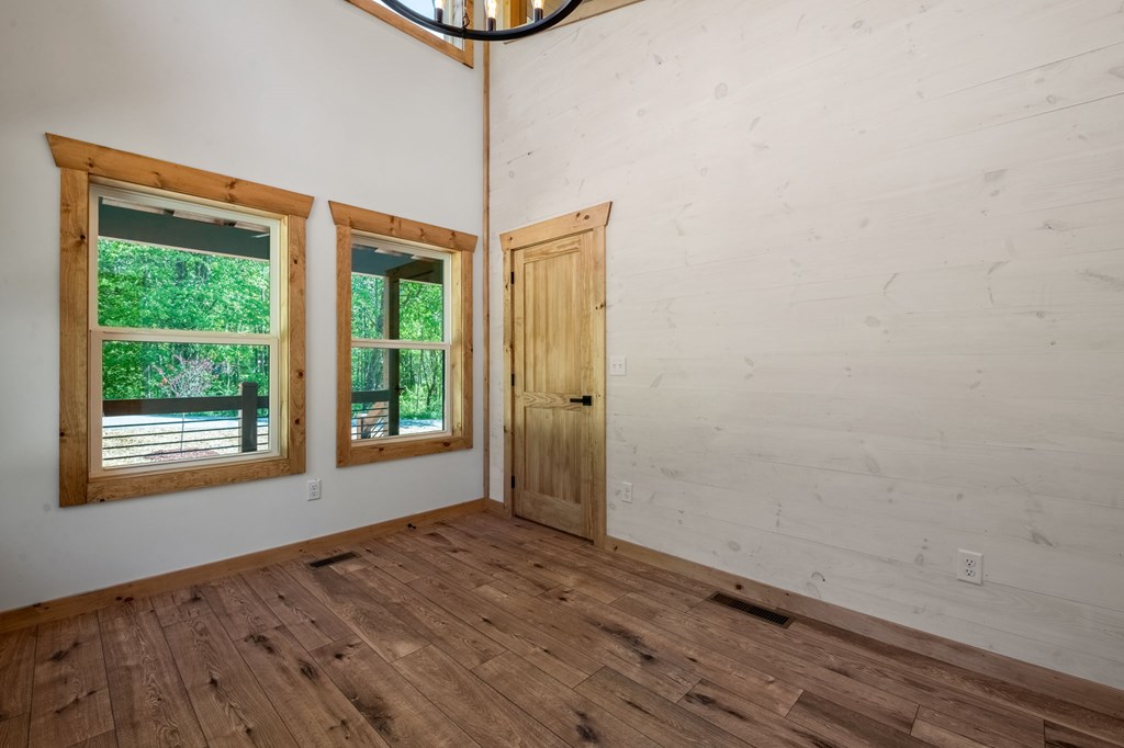 168 Ewing Street Blue Ridge, GA 30513 - Photo 31 of 46 a view of an empty room with a window and wooden floor