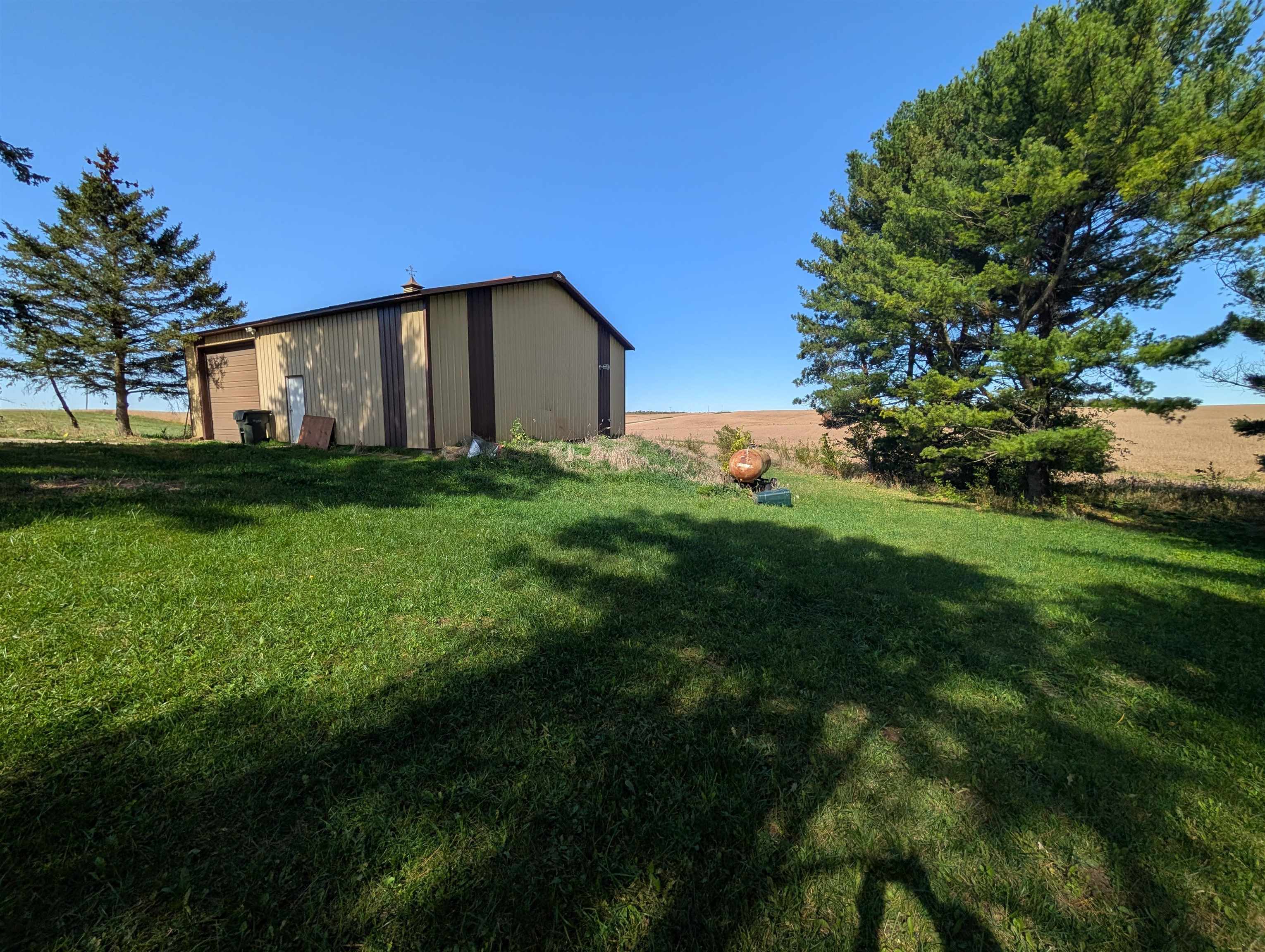 10740 North Barker Road Byron, IL 61010 - Photo 18 of 21 a backyard of a house with plants and large tree