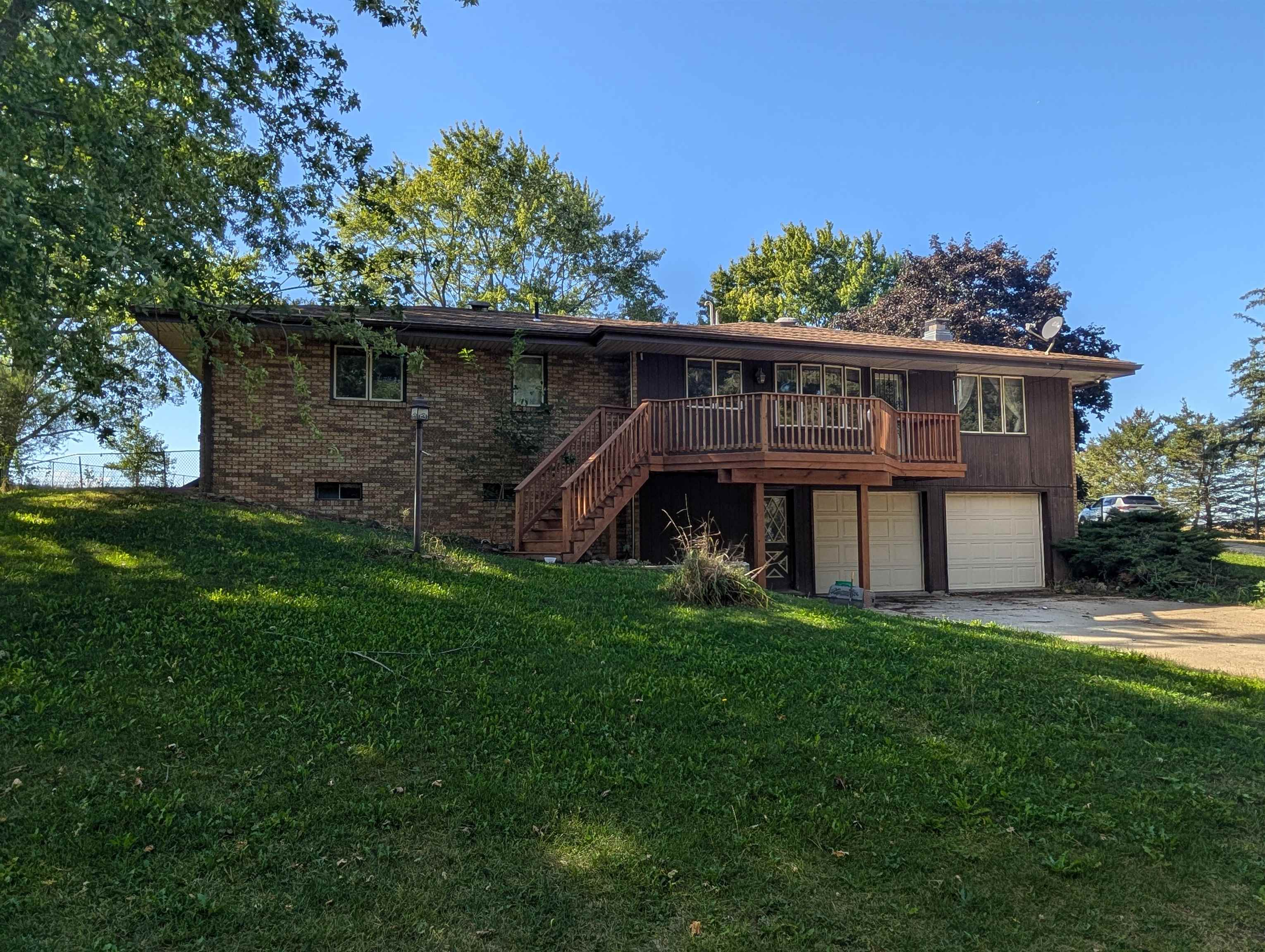 10740 North Barker Road Byron, IL 61010 - Photo 21 of 21 a view of a wooden house with a big yard and large trees