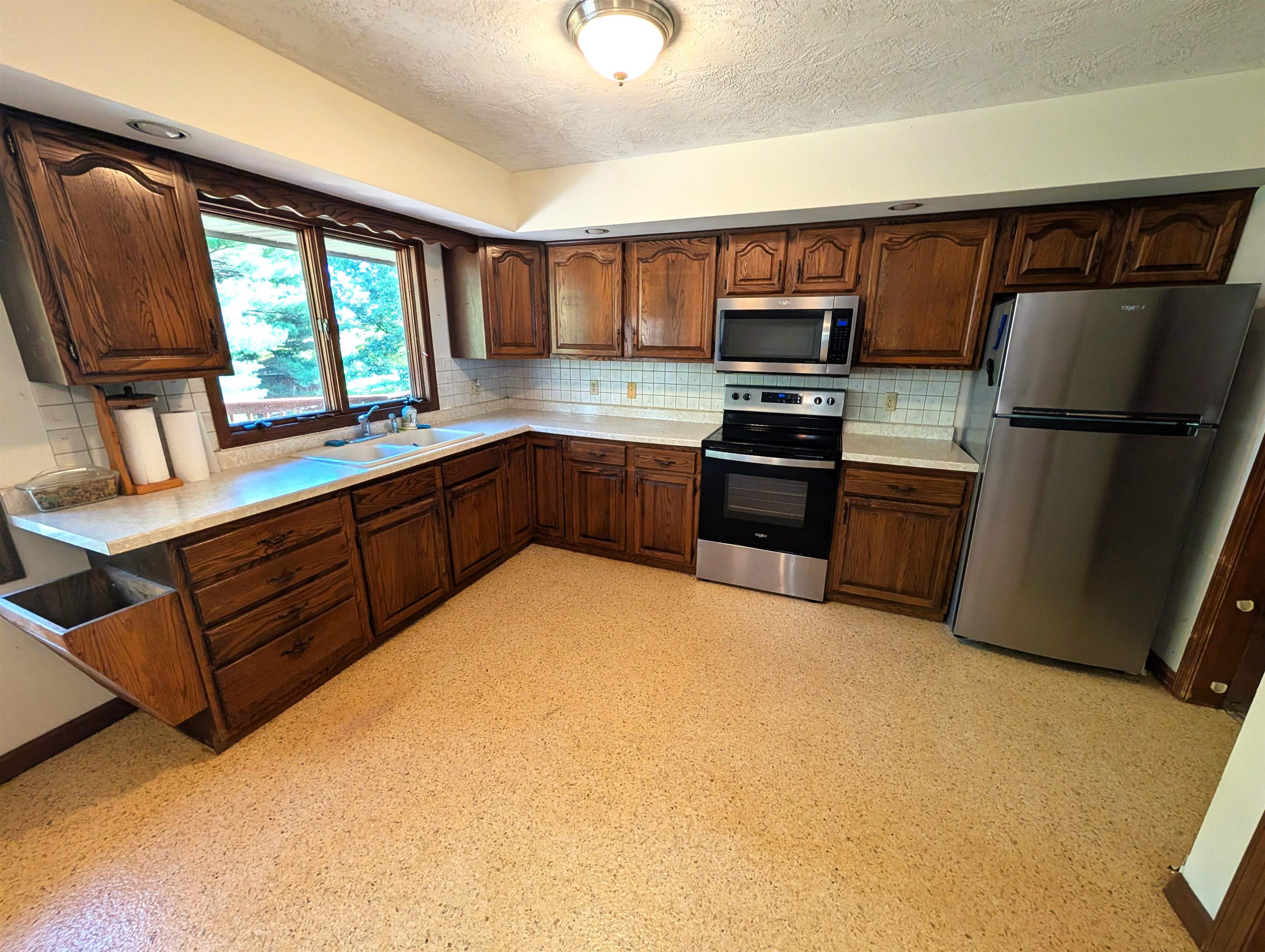 10740 North Barker Road Byron, IL 61010 - Photo 6 of 21 a kitchen with stainless steel appliances granite countertop a refrigerator and a stove top oven