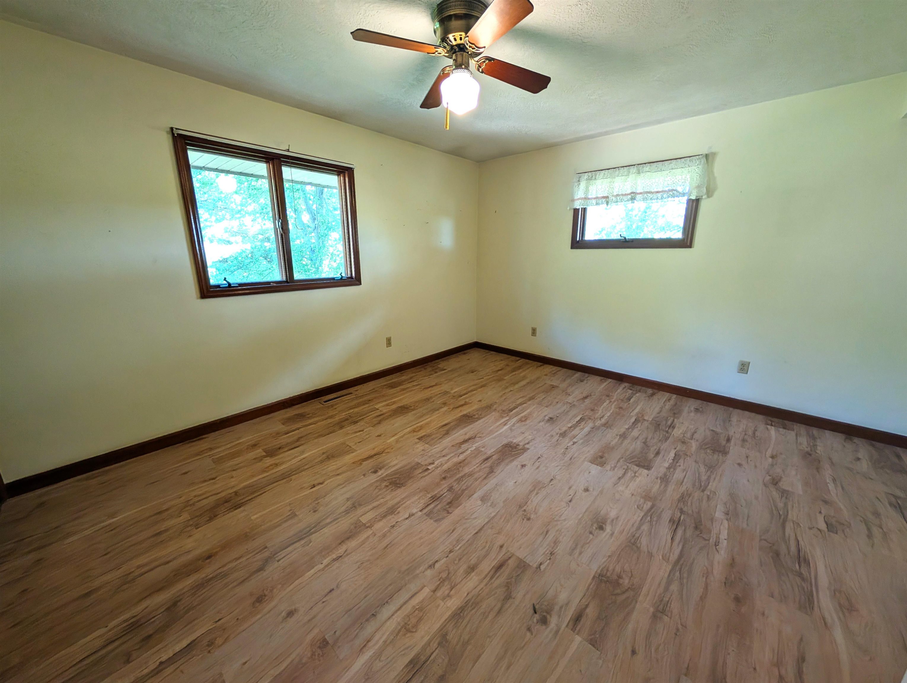 10740 North Barker Road Byron, IL 61010 - Photo 9 of 21 a view of an empty room with wooden floor and a window