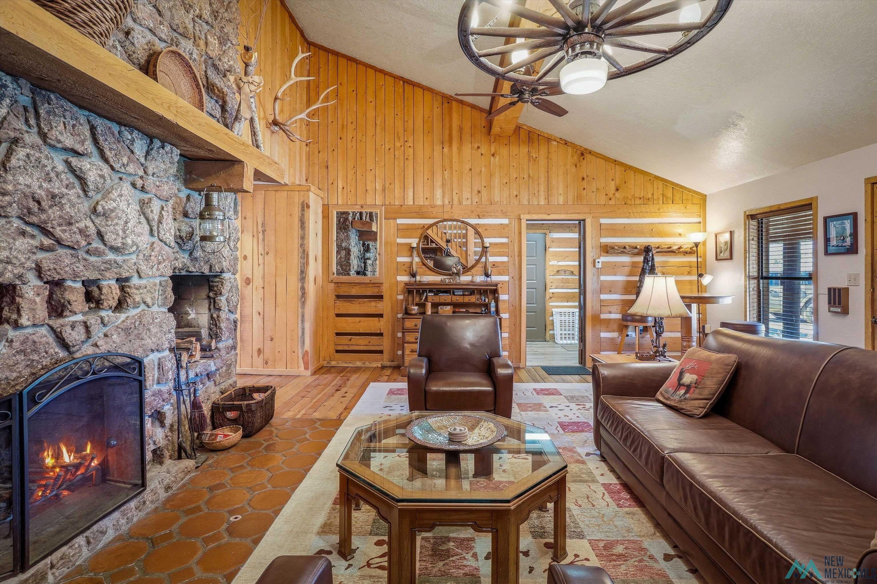 83 Juniper Road Chama, NM 87520 - Photo 6 of 56 Vaulted ceiling featuring wood paneling and a wagon wheel ceiling fan