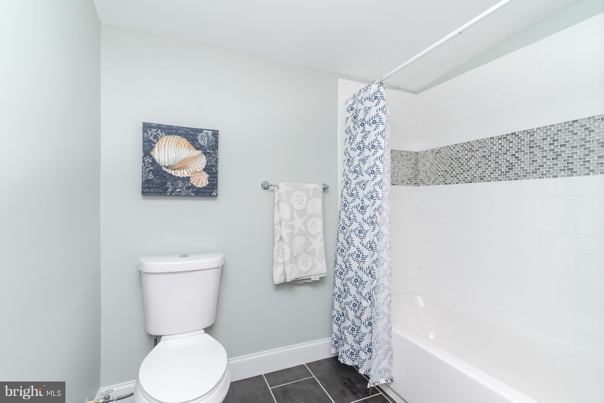 6306 Tramore Road Baltimore, MD 21214 - Photo 22 of 43 a white toilet sitting next to a bath tub