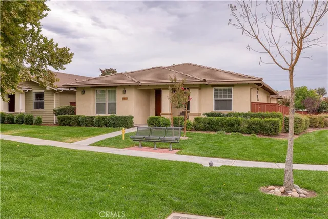 a view of a house with a yard and tree s