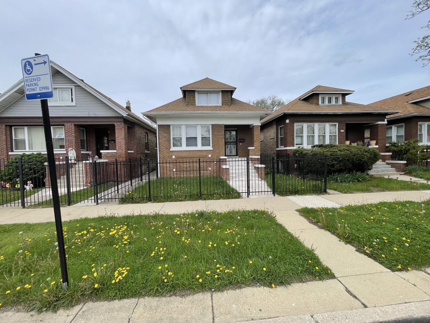 1512 North Linder Avenue Chicago, IL 60651 - Photo 2 of 19 a front view of a house with a yard