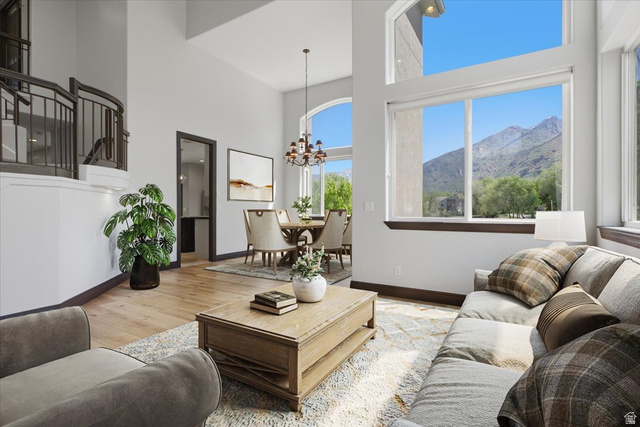 12317 Cypress Point Way Draper, UT 84020 - Photo 5 of 41 Vaulted ceilings living room/Formal Dining with expansive windows offering mountain scenery