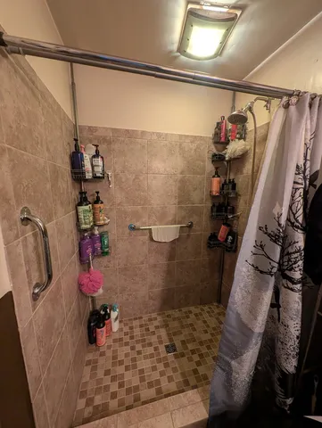 a room with gym equipment and a flat screen tv