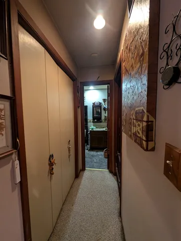 a living room with furniture a flat screen tv and kitchen view