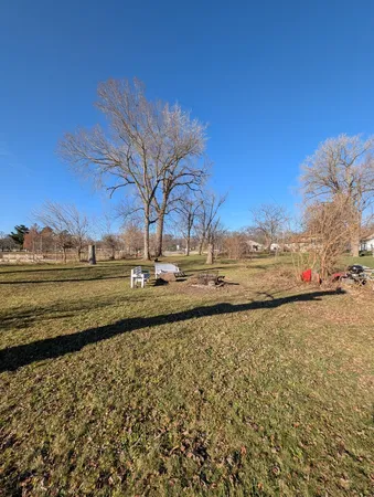 a view of a yard with wooden fence