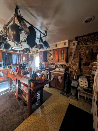 a living room with lots of furniture and chandelier