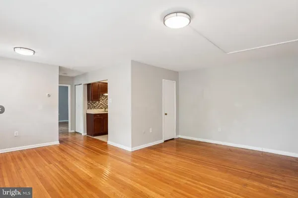 a view of empty room with wooden floor