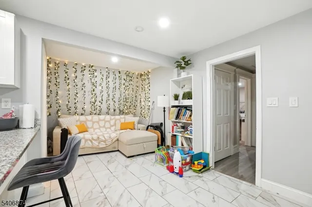 a bedroom with furniture and a potted plant
