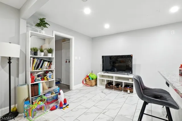 a bedroom with furniture and a flat screen tv