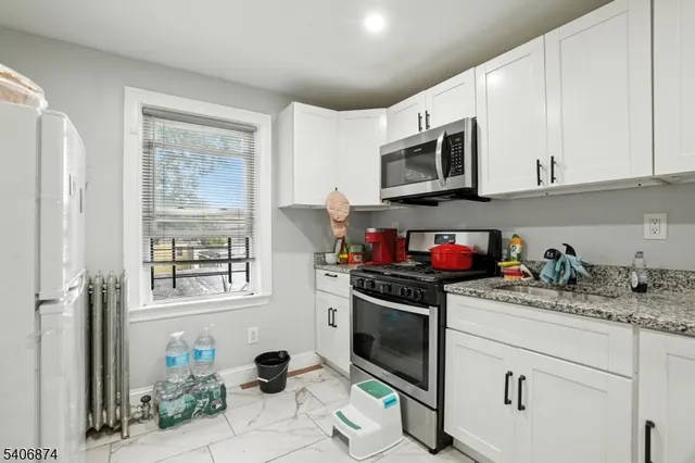 a kitchen with a stove a sink and a microwave