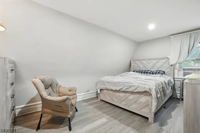 a bedroom with a bed and chair