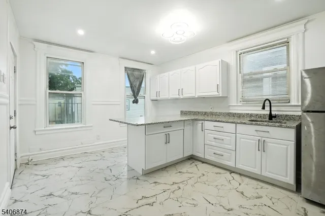 a kitchen that has a sink and a stove in it