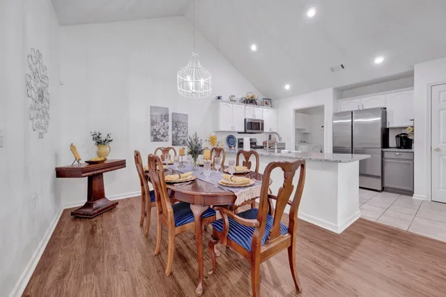 a bed room with a bed and a chandelier