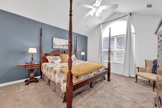 a bathroom with a granite countertop double vanity sink and mirror