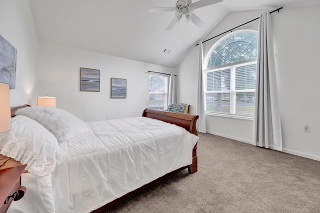 a bedroom with a bed and a chair