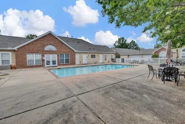 a front view of a house with a garden and yard