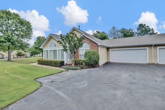 a view of a house with a yard and garage