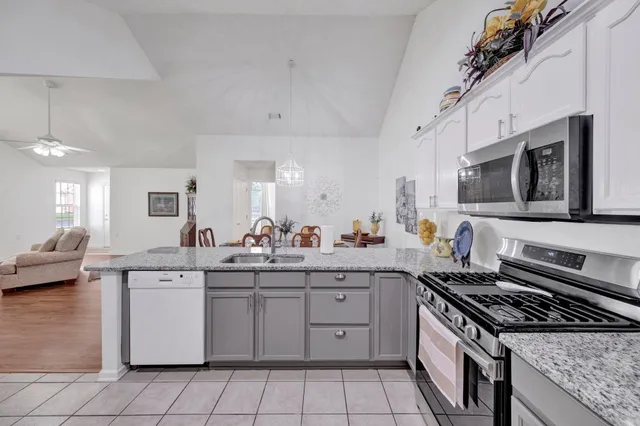 a kitchen that has a sink and a stove