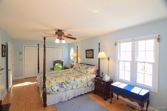 271 Burnt Wharf Road Lancaster, VA 22503 - Photo 3 of 35 a bedroom with a bed and wooden floor