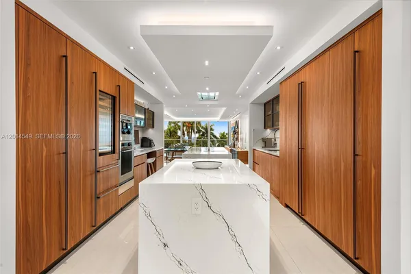 a large white kitchen with a large window