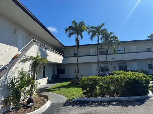 a view of a house with a flower garden