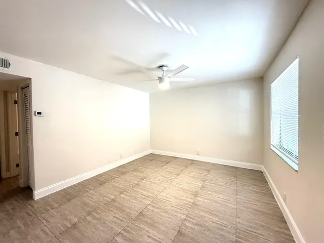 a view of an empty room with a window