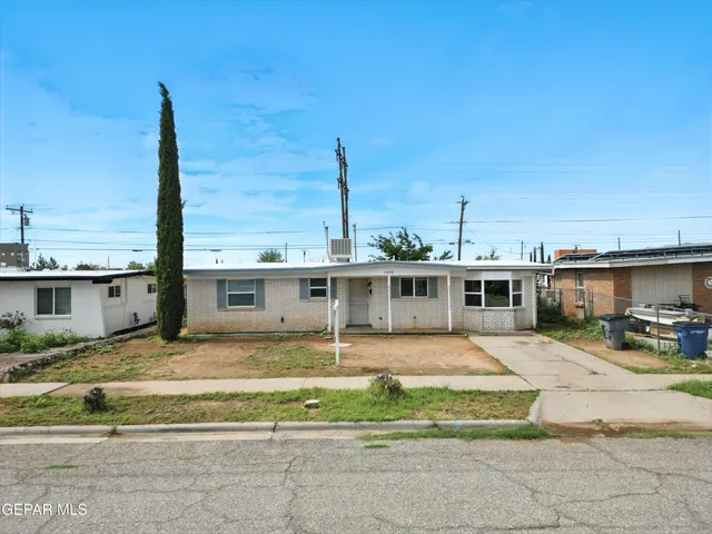 a view of a house with a backyard porch and sitting area