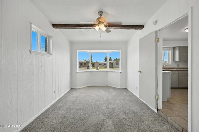 a view of an empty room with a kitchen