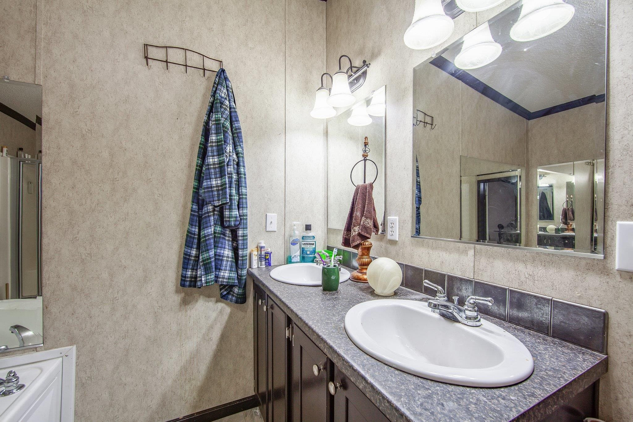 1040 River Road Bolivar, TN 38008 - Photo 11 of 27 a bathroom with a granite countertop sink a toilet and a mirror