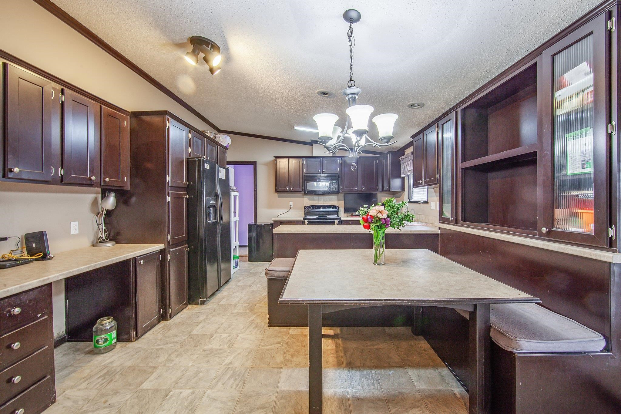1040 River Road Bolivar, TN 38008 - Photo 17 of 27 a view of a dining room kitchen and a chandelier