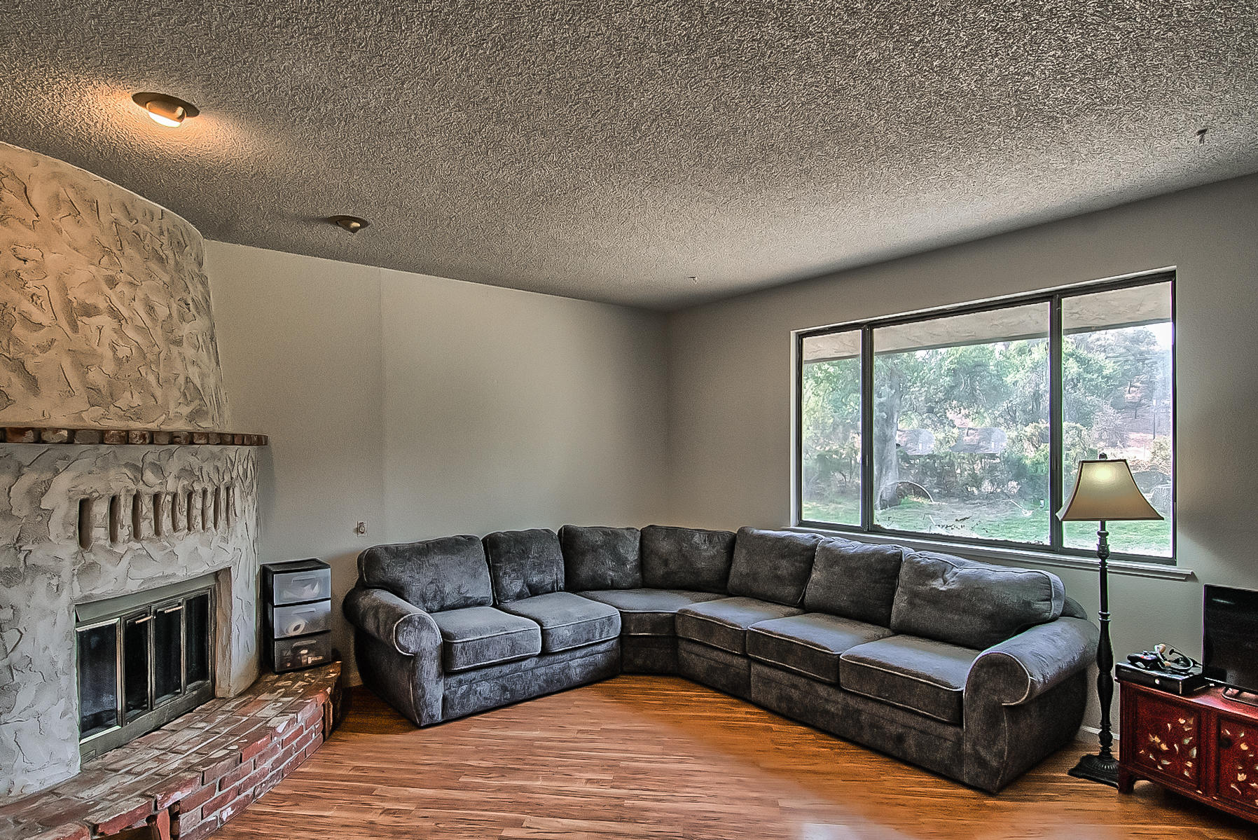 21310 Dersch Road Anderson, CA 96007 - Photo 5 of 35 a living room with furniture a fireplace and a large window
