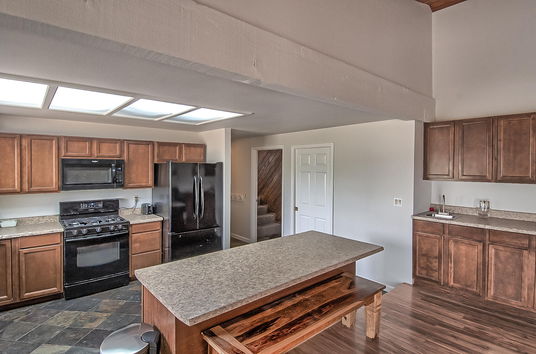 21310 Dersch Road Anderson, CA 96007 - Photo 9 of 35 a kitchen with stainless steel appliances granite countertop a stove a sink dishwasher and a refrigerator with wooden floor