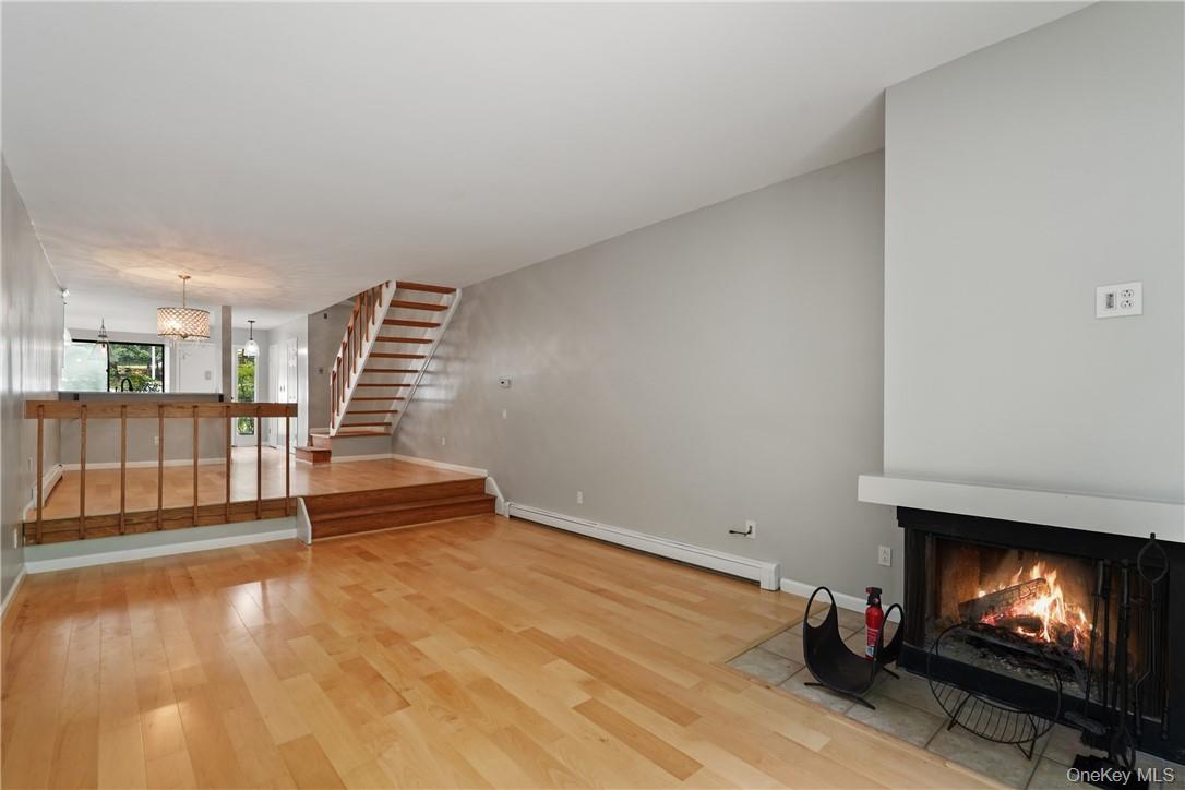 118 Round Hill Road Dobbs Ferry, NY 10522 - Photo 12 of 16 an empty room with wooden floor and windows