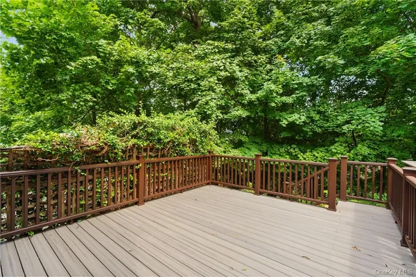 a balcony with wooden floor and fence