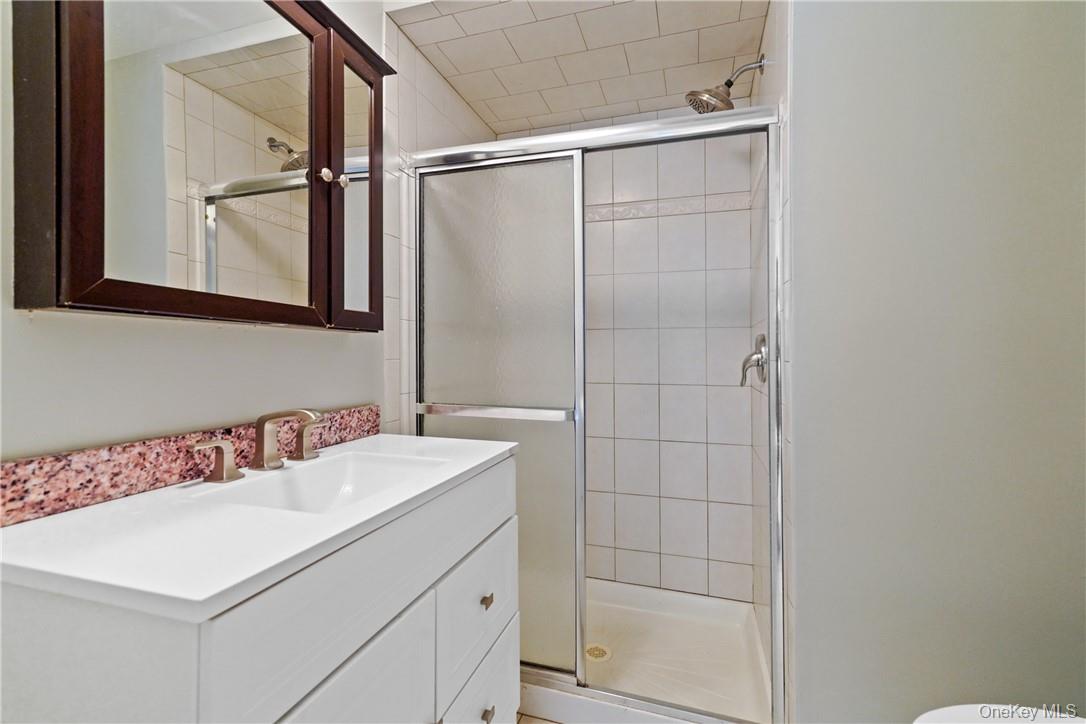 118 Round Hill Road Dobbs Ferry, NY 10522 - Photo 6 of 16 a bathroom with a sink a vanity and a mirror