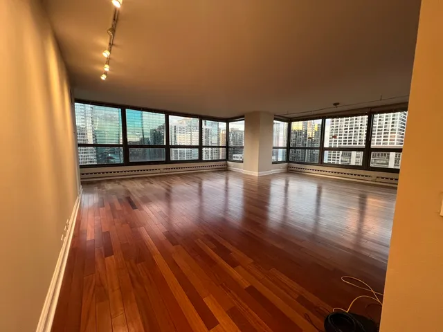 wooden floor in an empty room with a window