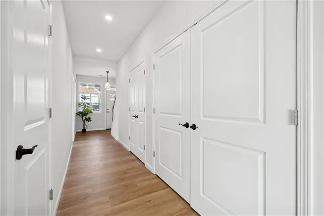a view of a hallway with wooden floor