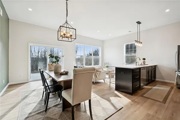 a dining room with furniture window and wooden floor