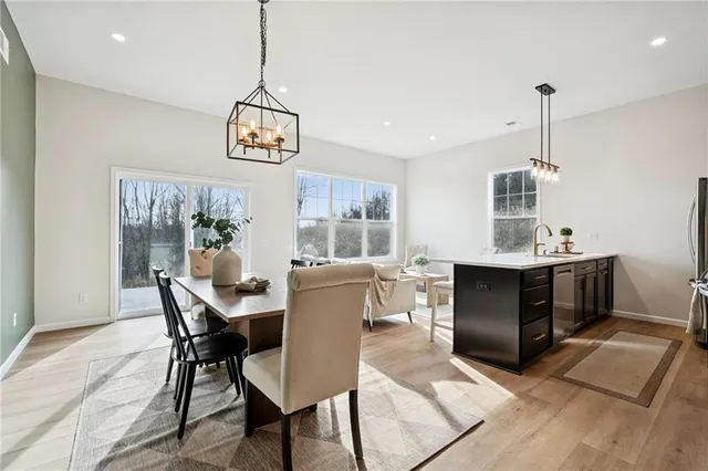 a dining room with furniture window and wooden floor