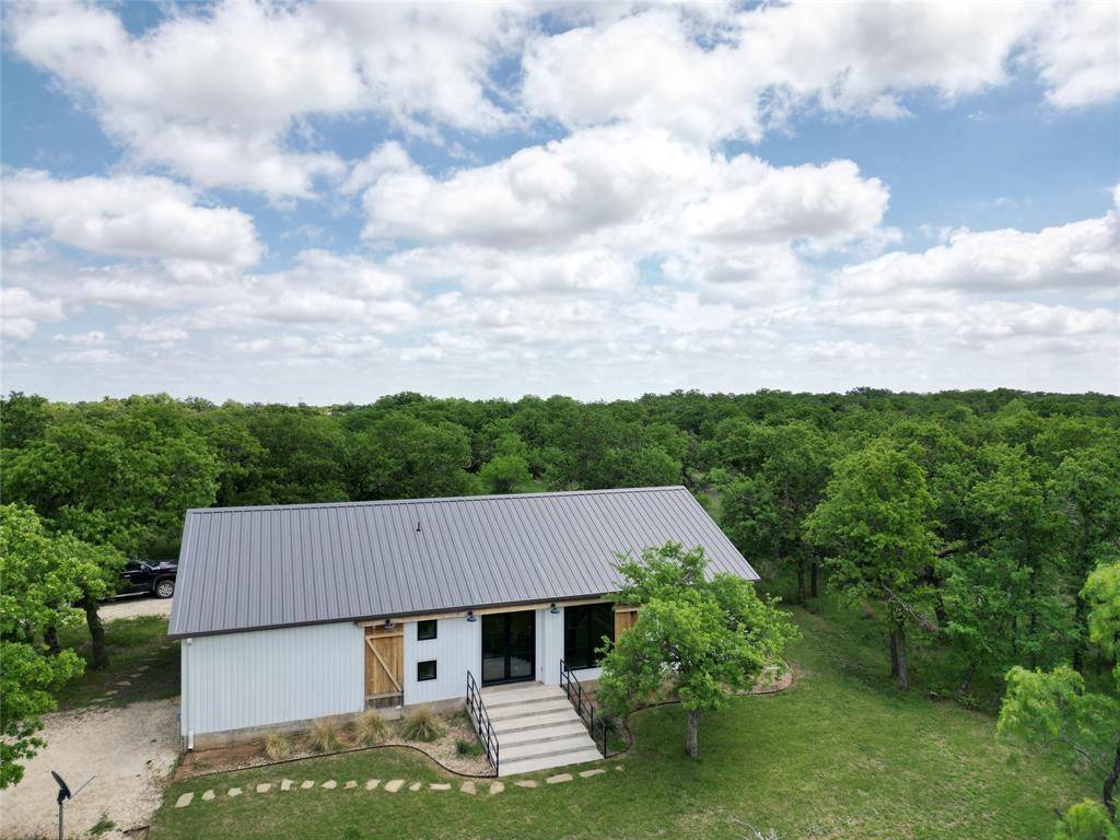 Charming barndominium nestled among mature post oaks with scenic views and private surroundings.