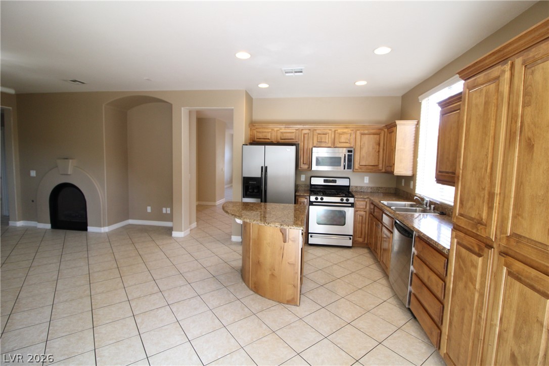 754 Rise Canyon Drive Henderson, NV 89052 - Photo 7 of 34 A generously sized kitchen featuring a peninsula, stainless steel appliances, and ample cabinet storage.