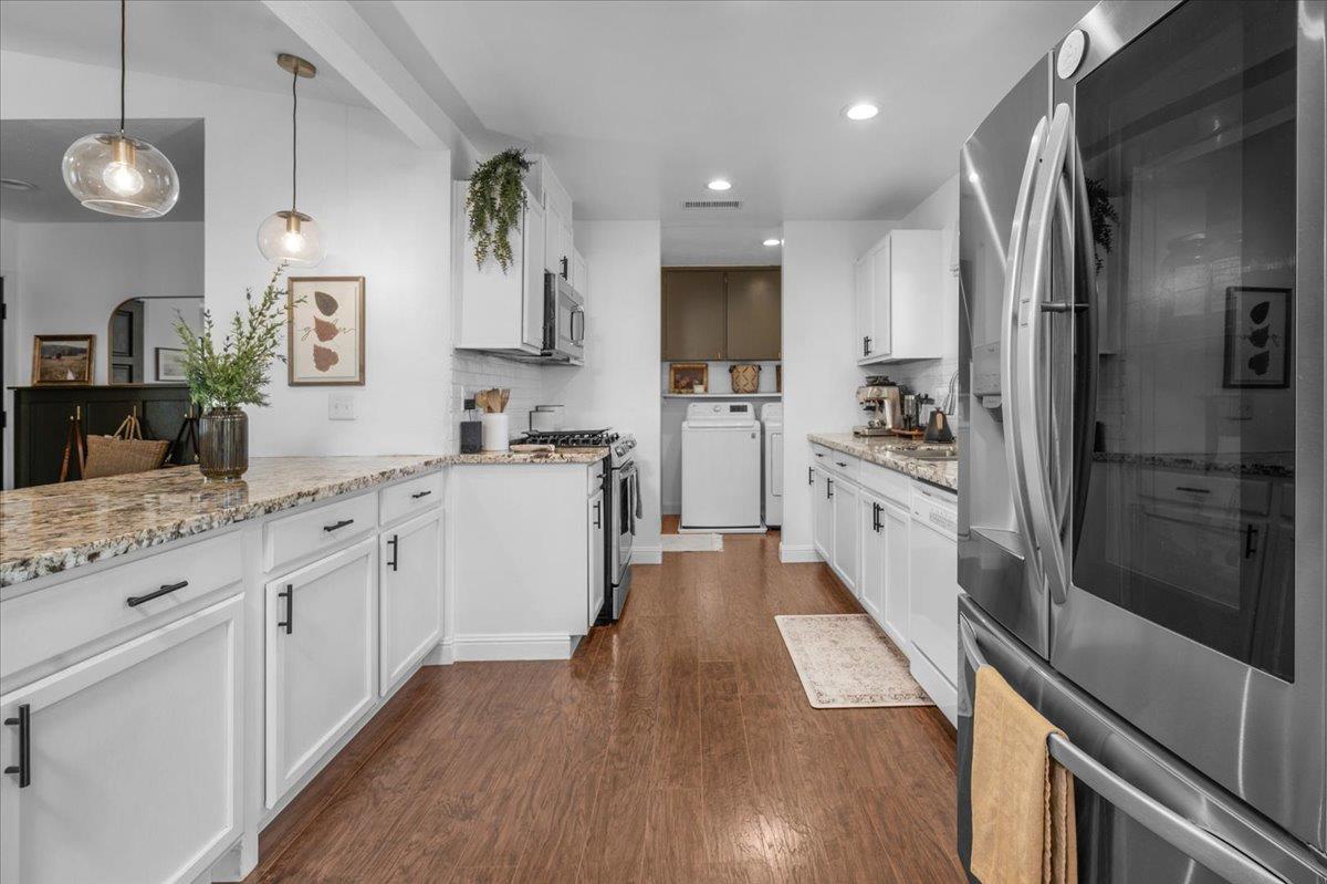 1448 Ashcroft Avenue Clovis, CA 93611 - Photo 11 of 46 a large kitchen with granite countertop a large counter top appliances and cabinets