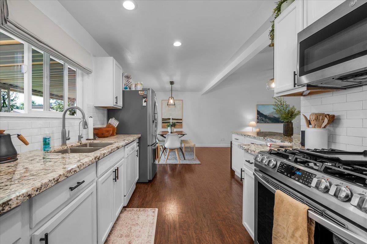 1448 Ashcroft Avenue Clovis, CA 93611 - Photo 13 of 46 a kitchen with stove and wooden floor