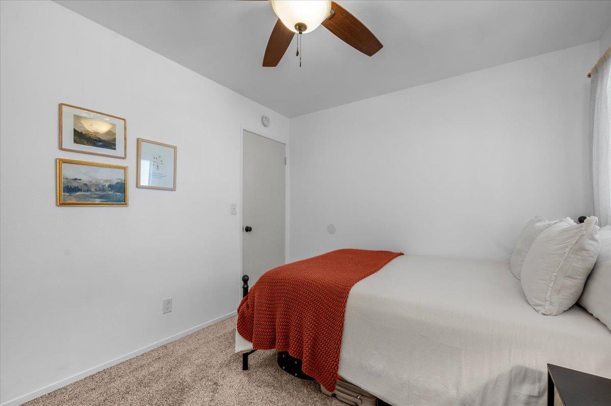 1448 Ashcroft Avenue Clovis, CA 93611 - Photo 20 of 46 a bedroom with a bed and a ceiling fan