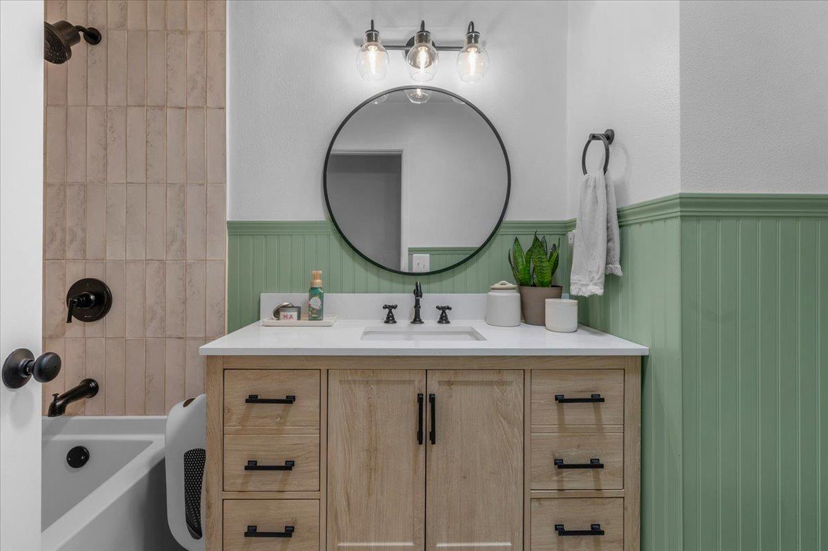 1448 Ashcroft Avenue Clovis, CA 93611 - Photo 21 of 46 a bathroom with a sink and a mirror