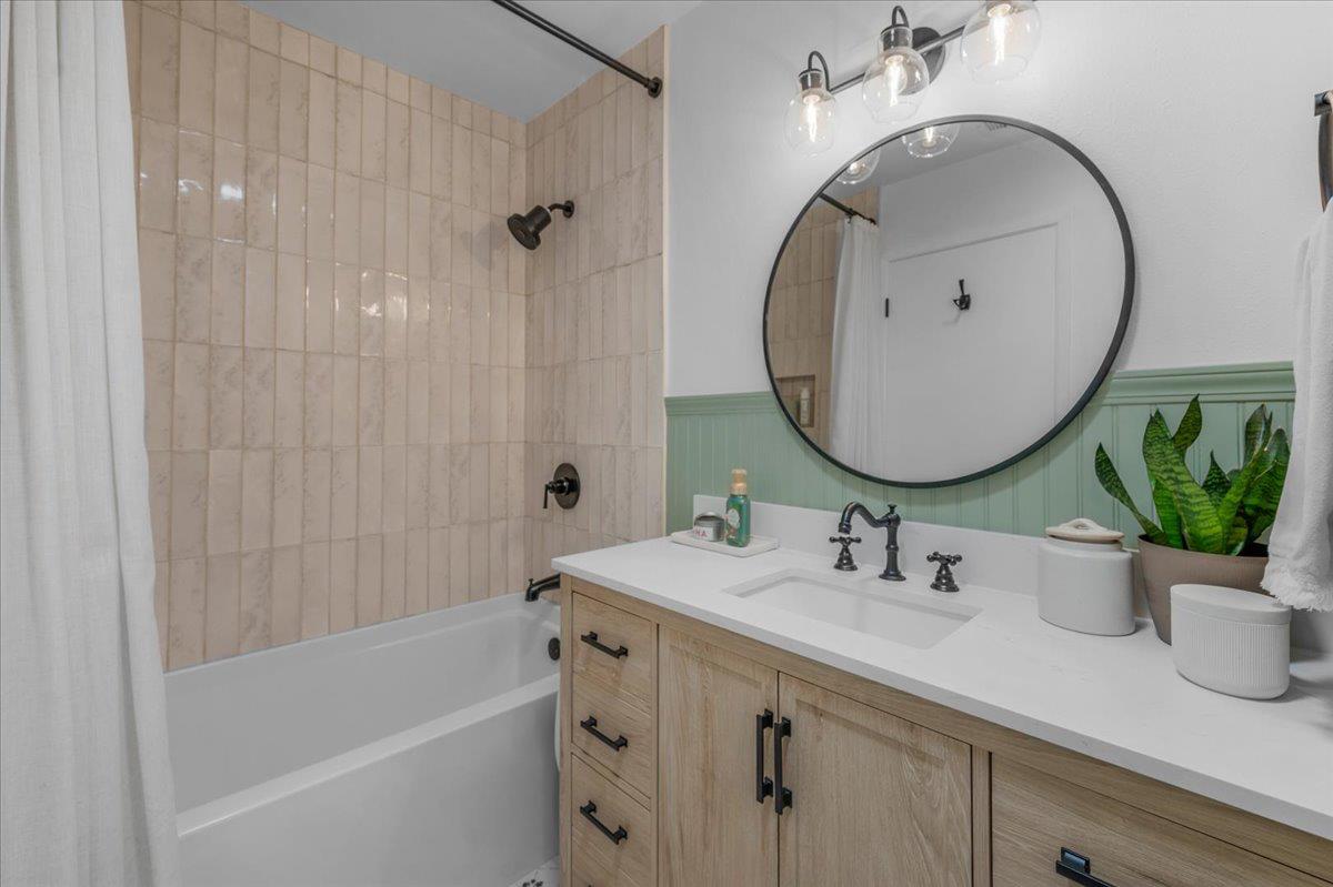 1448 Ashcroft Avenue Clovis, CA 93611 - Photo 22 of 46 a bathroom with a sink a mirror a bathtub and shower